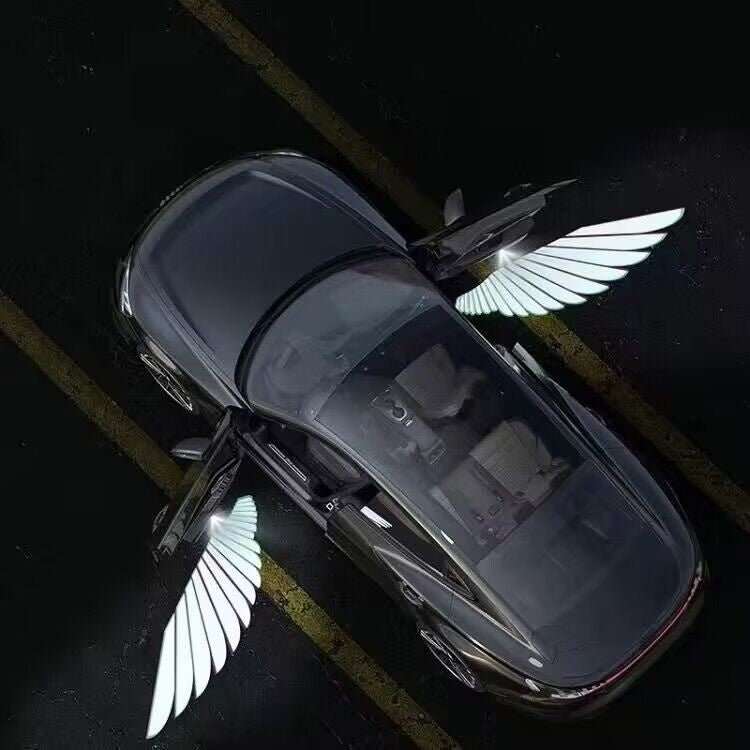 Car with door sill light projection displaying illuminated wings from open doors at night